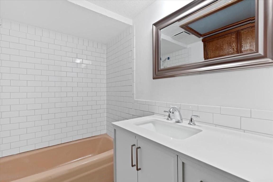 502 Grace Lane Austin, TX 78746 - Photo 19 of 37 a bathroom with a sink and a bathtub