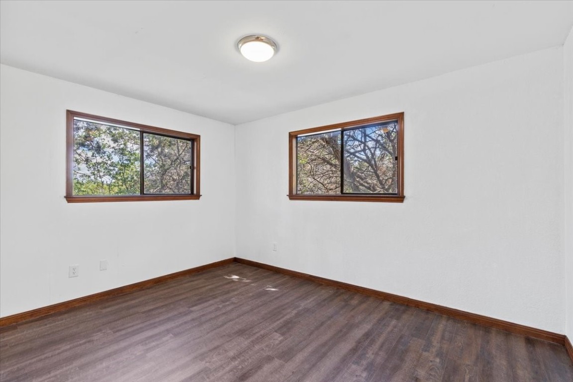 502 Grace Lane Austin, TX 78746 - Photo 34 of 37 a view of an empty room with wooden floor and window