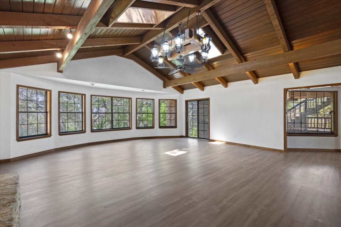 502 Grace Lane Austin, TX 78746 - Photo 7 of 37 a view of an empty room with wooden floor and a window