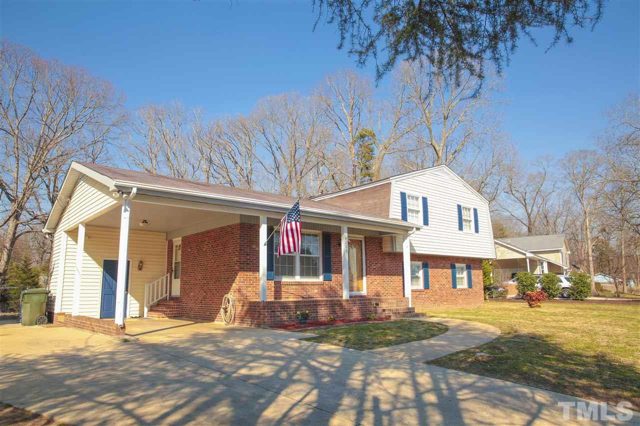 4105 Willow Oak Road Raleigh, NC 27604 - Photo 5 of 8 a front view of a house with a yard and garage