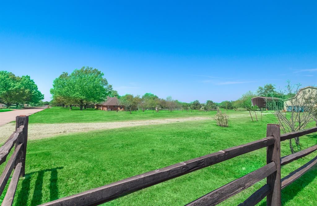13 Crestview Circle Rockwall, TX 75087 - Photo 37 of 37 a view of a green field with wooden fence