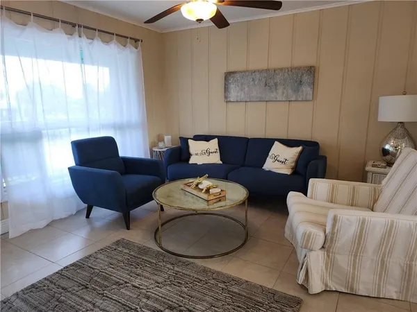 a living room with furniture and a large window