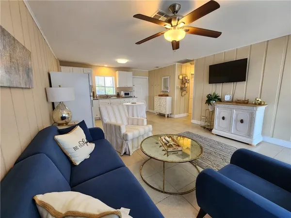 a living room with furniture and a flat screen tv