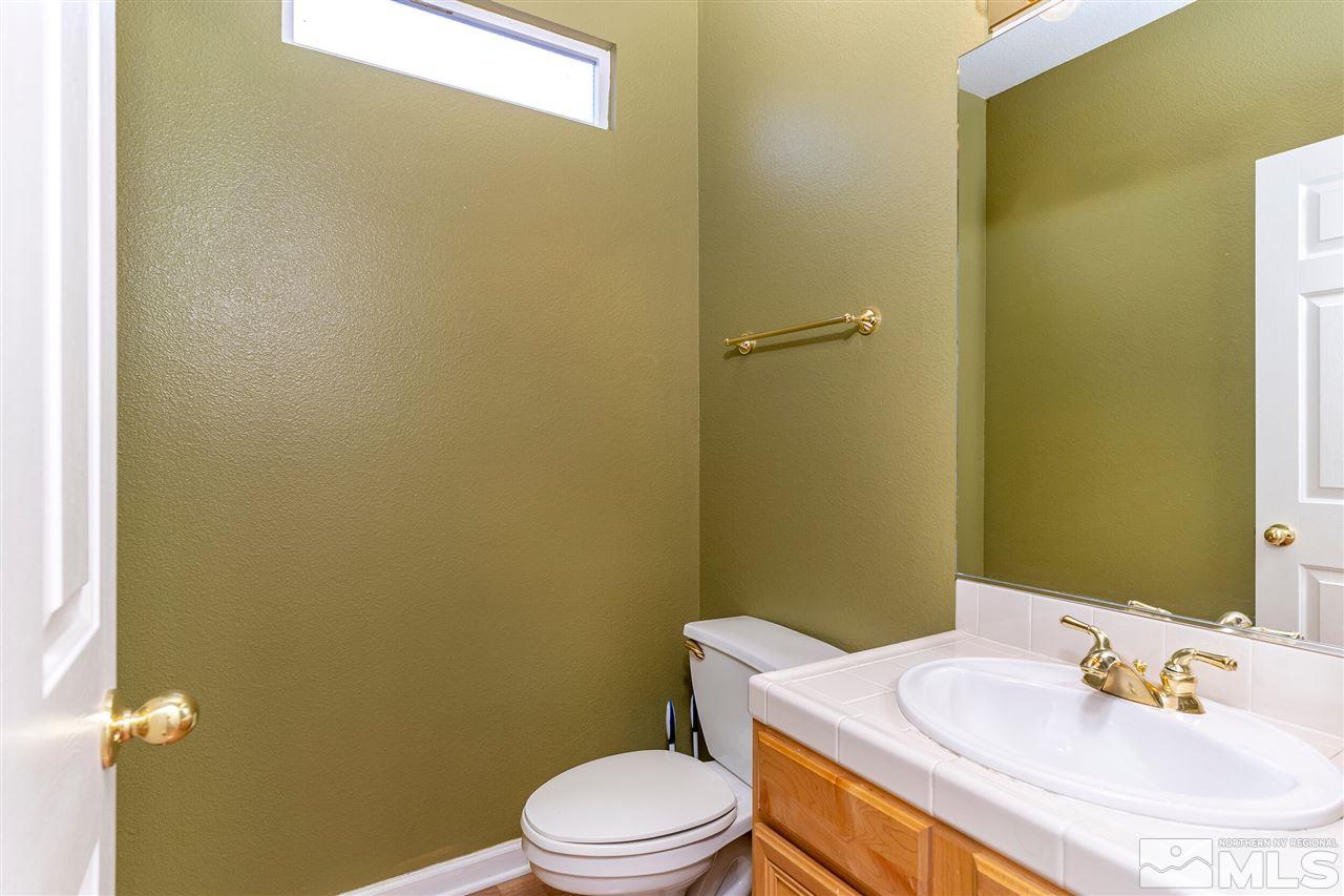 805 Caughlin Crossing Reno, NV 89519 - Photo 11 of 31 a bathroom with a sink a toilet and mirror