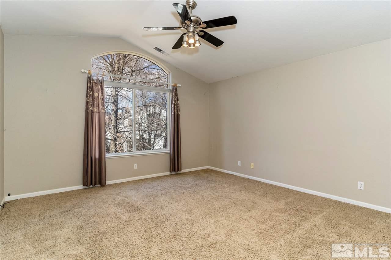 805 Caughlin Crossing Reno, NV 89519 - Photo 12 of 31 an empty room with chandelier fan