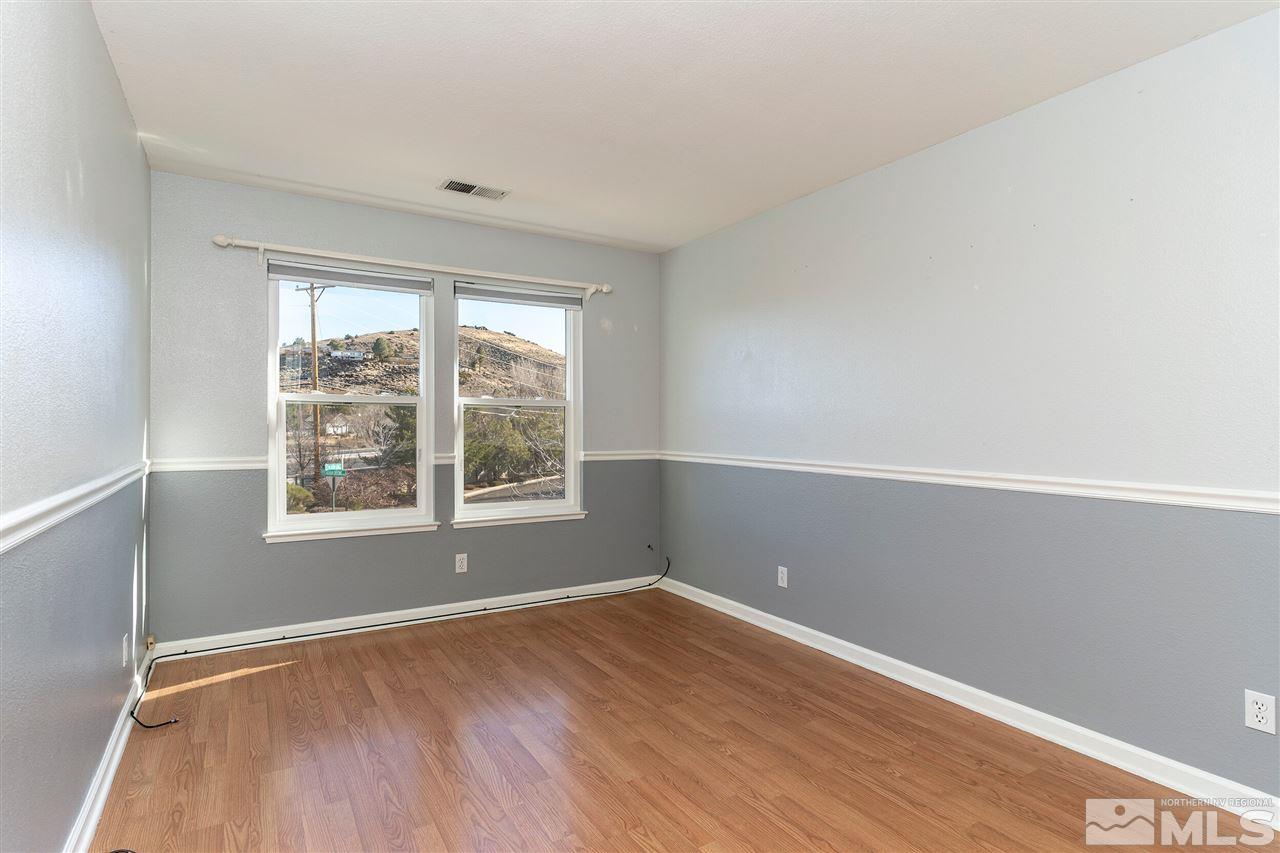 805 Caughlin Crossing Reno, NV 89519 - Photo 17 of 31 an empty room with wooden floor and windows