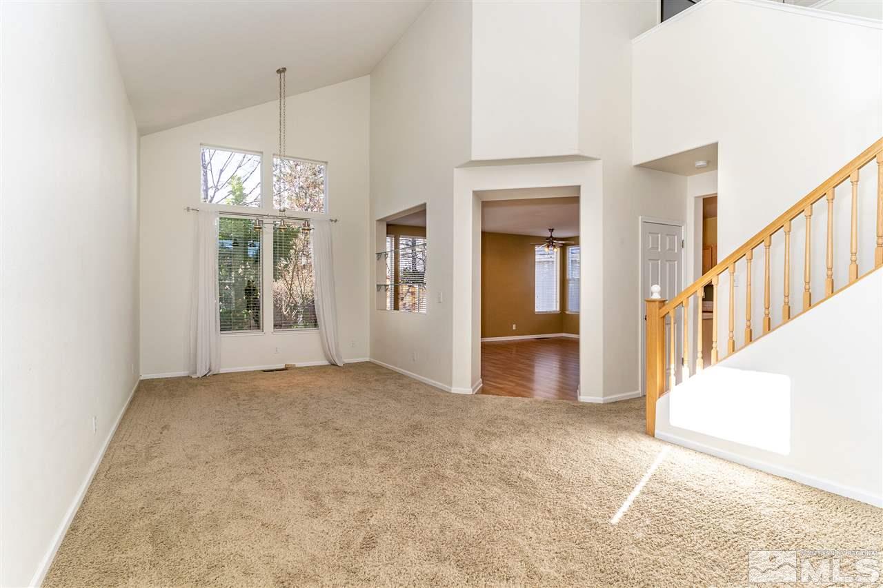 805 Caughlin Crossing Reno, NV 89519 - Photo 3 of 31 an empty room with chandelier fan and windows