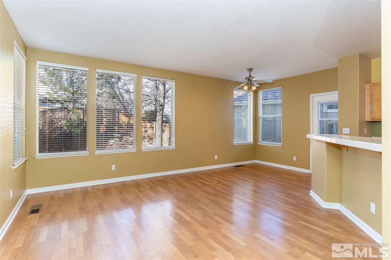 805 Caughlin Crossing Reno, NV 89519 - Photo 5 of 31 a view of empty room with wooden floor and fan