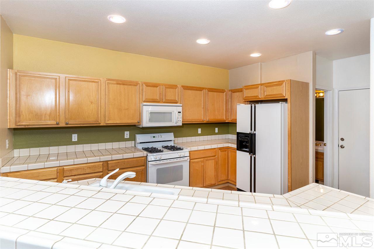 805 Caughlin Crossing Reno, NV 89519 - Photo 8 of 31 a kitchen with stainless steel appliances a refrigerator sink and microwave