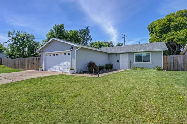 a view of a house with a yard and a garden