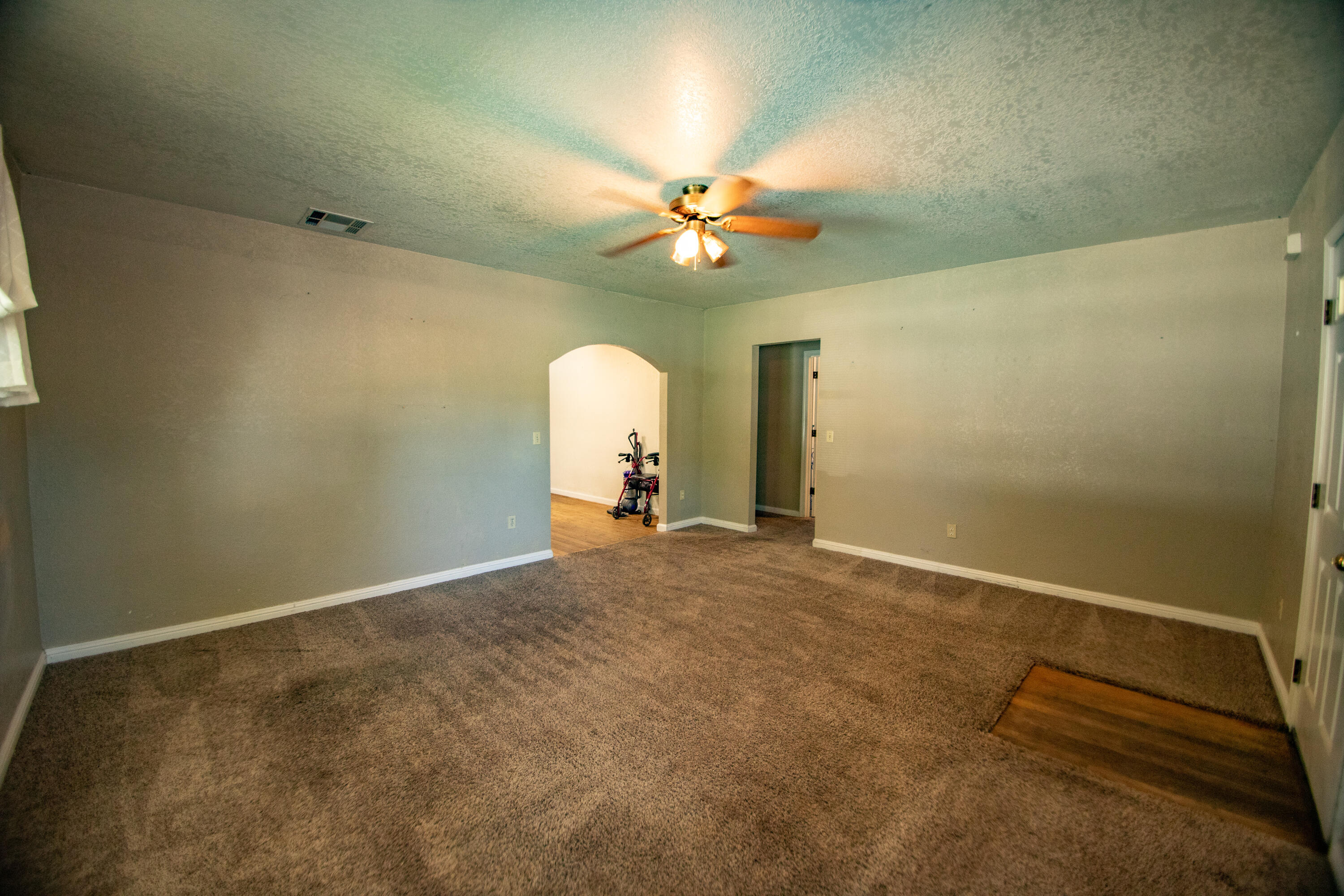 856 State Street Redding, CA 96001 - Photo 11 of 13 an empty room with a chandelier fan and a window
