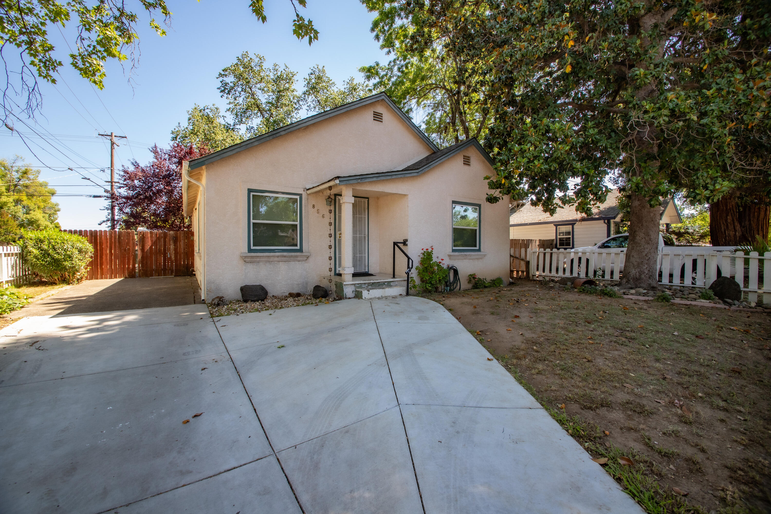 856 State Street Redding, CA 96001 - Photo 13 of 13 a backyard of a house with table and chairs under an umbrella