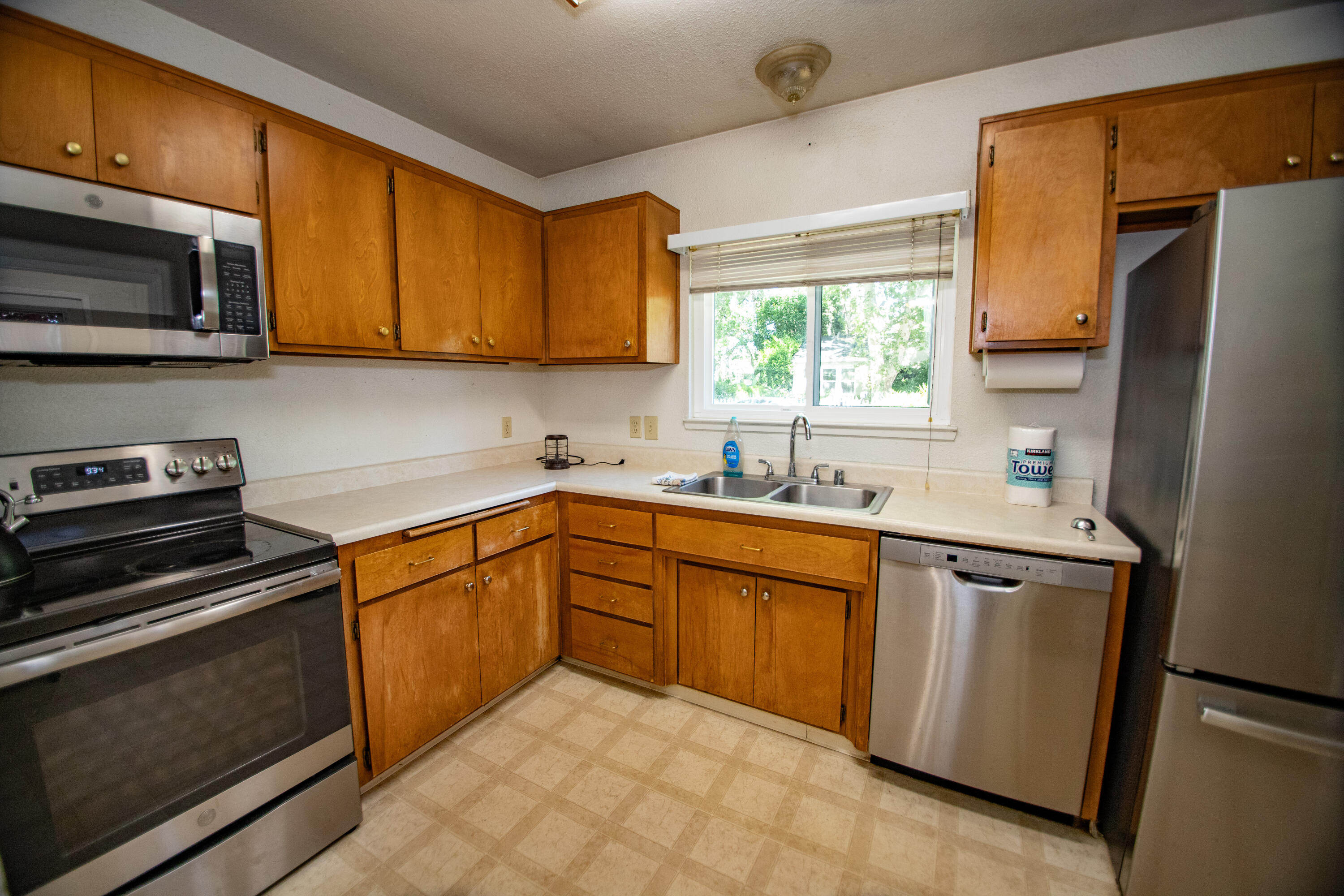 856 State Street Redding, CA 96001 - Photo 3 of 13 a kitchen with stainless steel appliances granite countertop wooden cabinets a stove top oven a sink and dishwasher