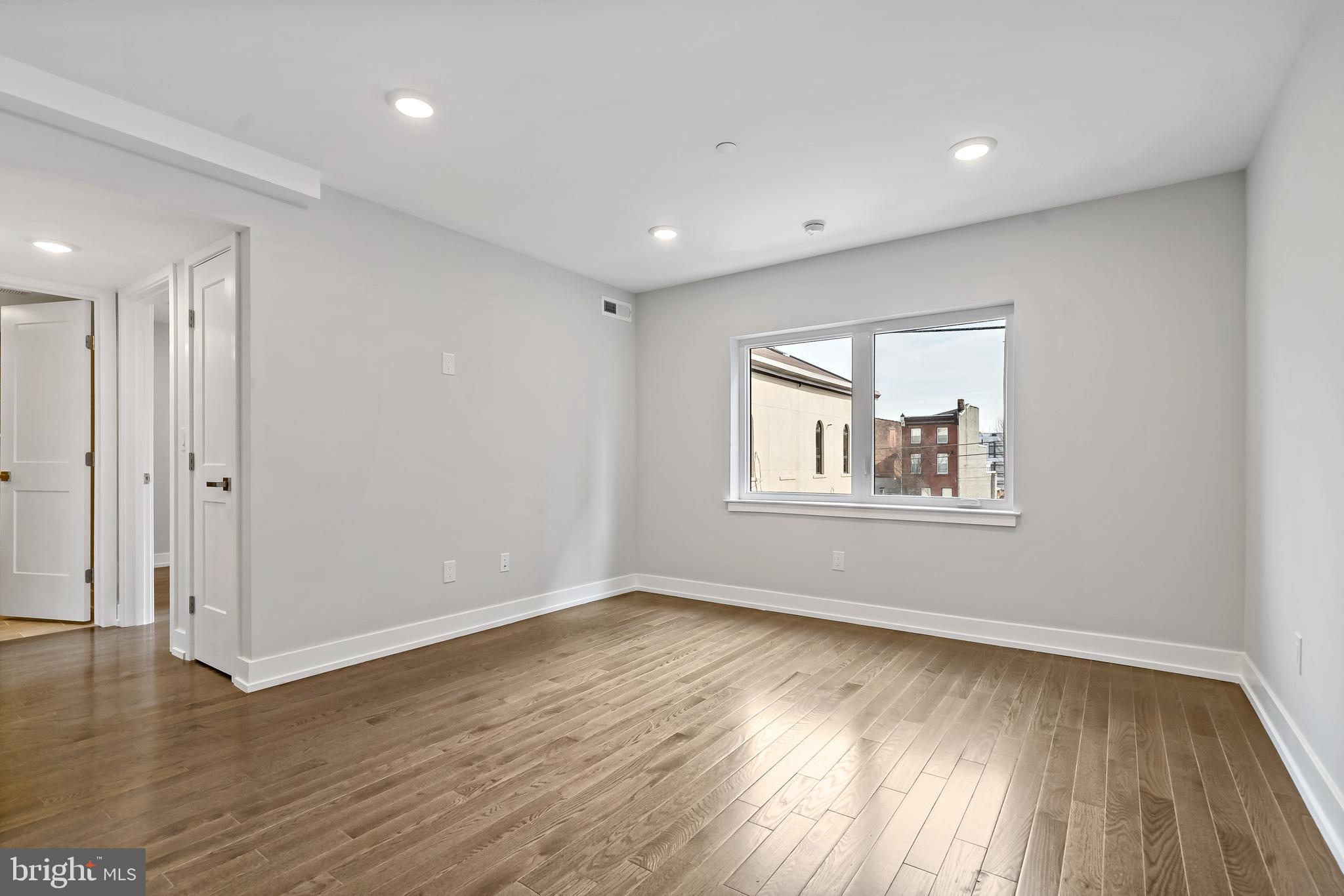 1530 Palethorp Street, Unit 2B Philadelphia, PA 19122 - Photo 4 of 15 a view of empty room with wooden floor and fan