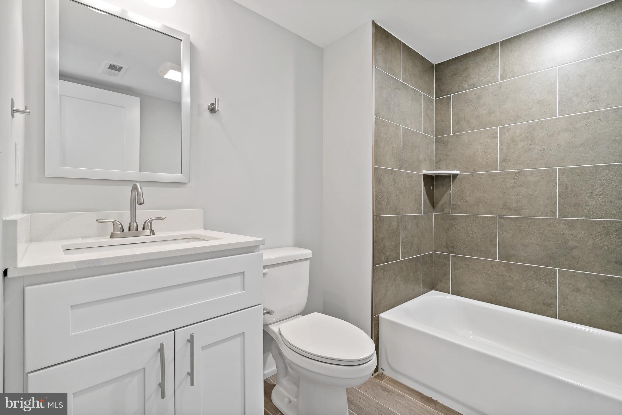 1530 Palethorp Street, Unit 2B Philadelphia, PA 19122 - Photo 6 of 15 a bathroom with a sink a toilet and bathtub
