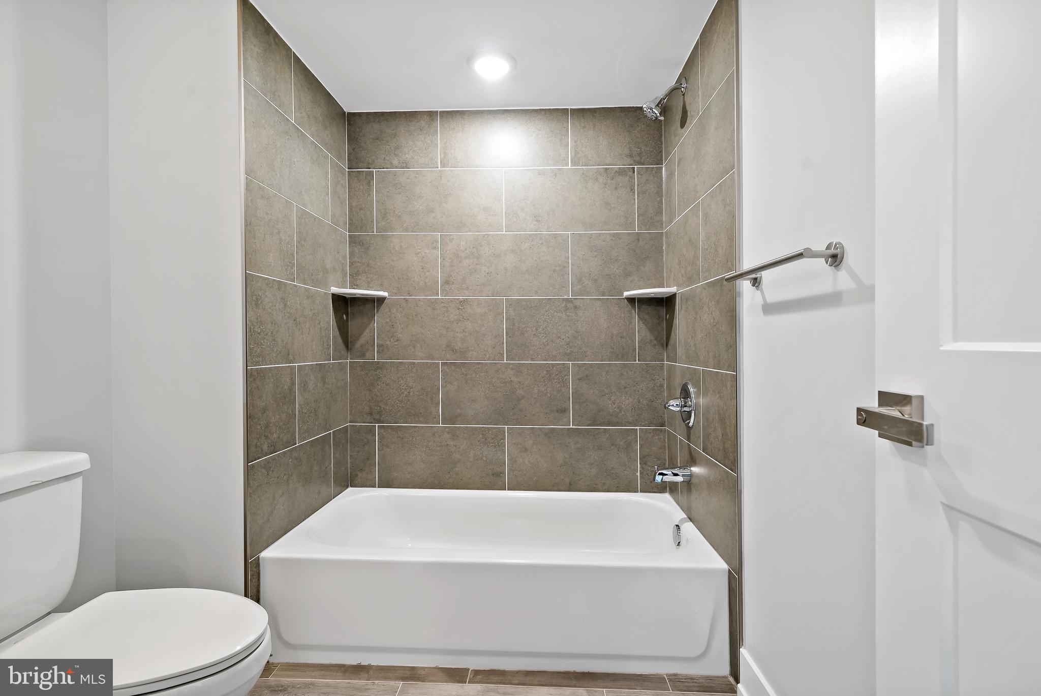 1530 Palethorp Street, Unit 2B Philadelphia, PA 19122 - Photo 7 of 15 a bathroom with a bathtub and a toilet