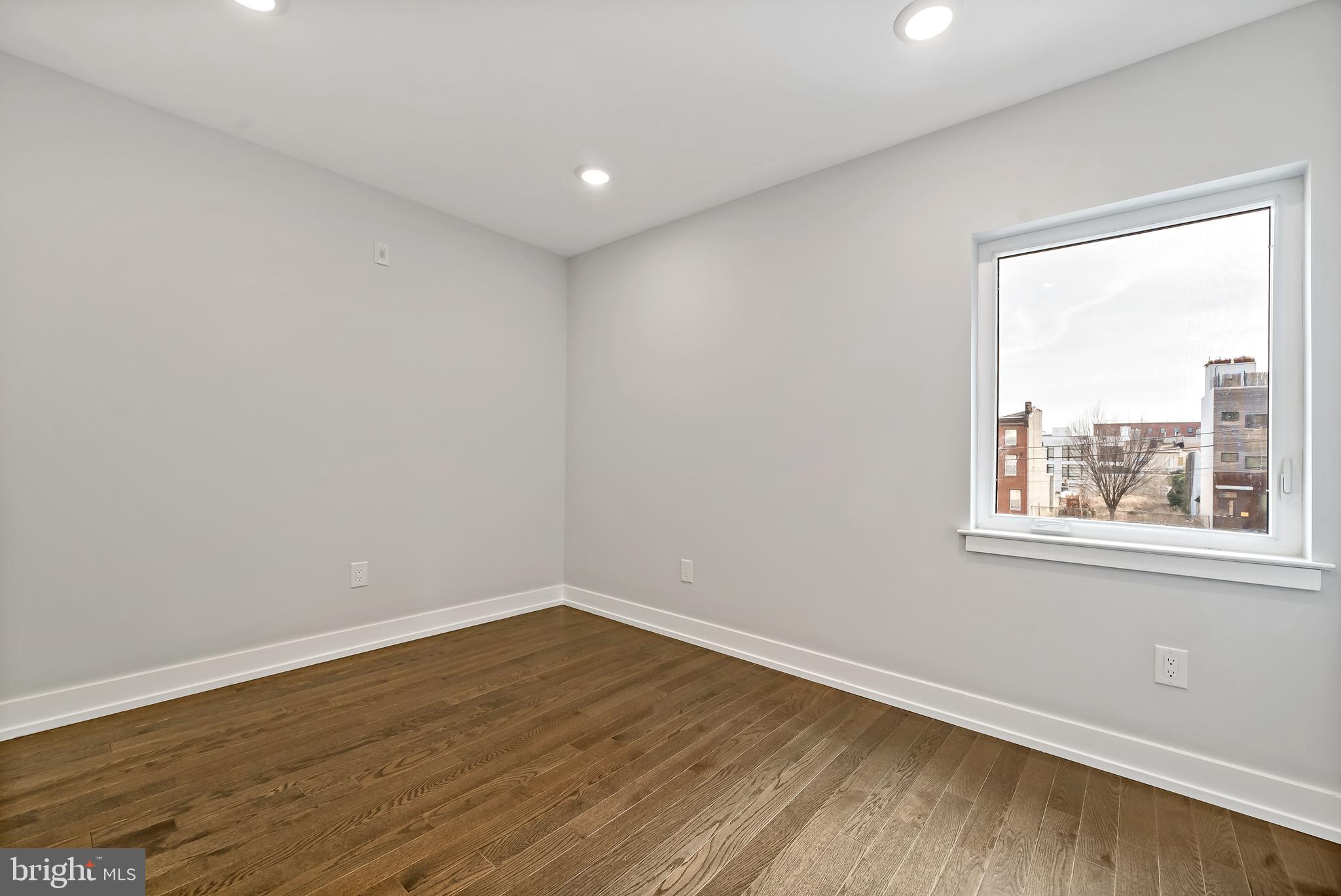 1530 Palethorp Street, Unit 2B Philadelphia, PA 19122 - Photo 9 of 15 a view of empty room with wooden floor and fan
