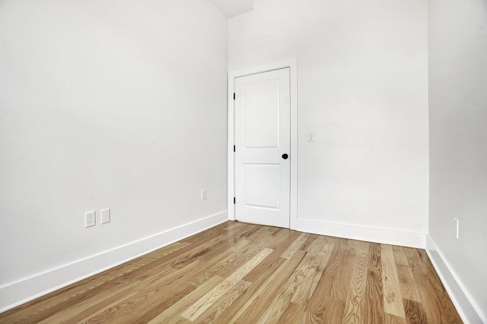 34 Van Reypen Street, Unit 2 Jersey City, NJ 07306 - Photo 21 of 25 a view of an empty room with wooden floor