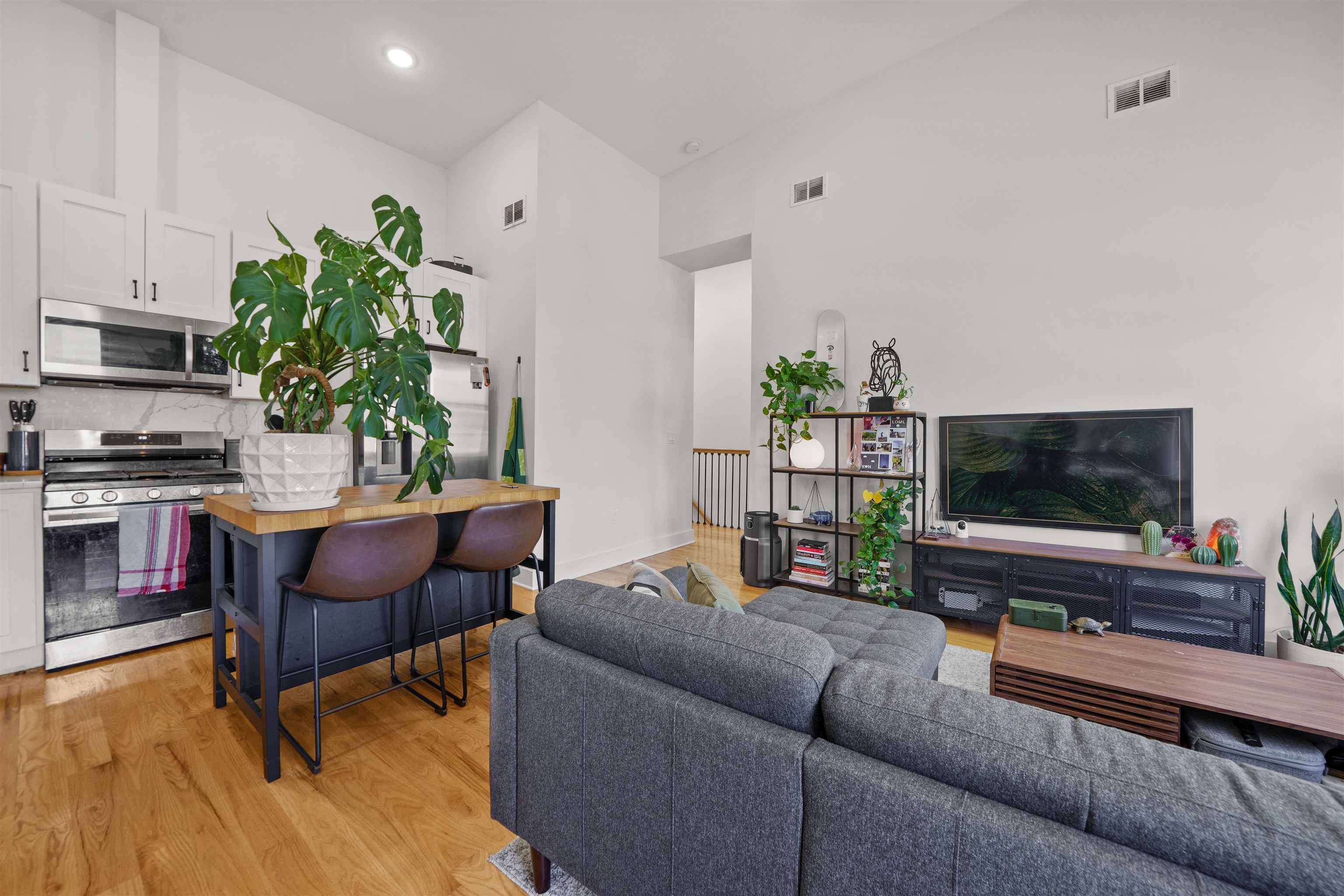 34 Van Reypen Street, Unit 2 Jersey City, NJ 07306 - Photo 6 of 25 a living room with furniture and a flat screen tv