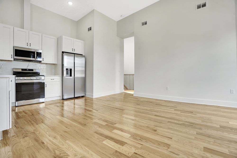 34 Van Reypen Street, Unit 2 Jersey City, NJ 07306 - Photo 7 of 25 a view of kitchen with stainless steel appliances wooden floor and electronic appliances