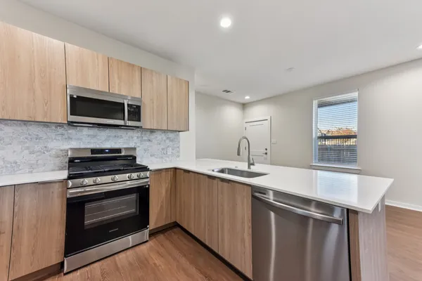 a kitchen with a refrigerator sink and microwave