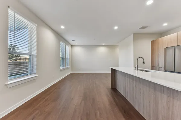 a living room with furniture kitchen view and a flat screen tv