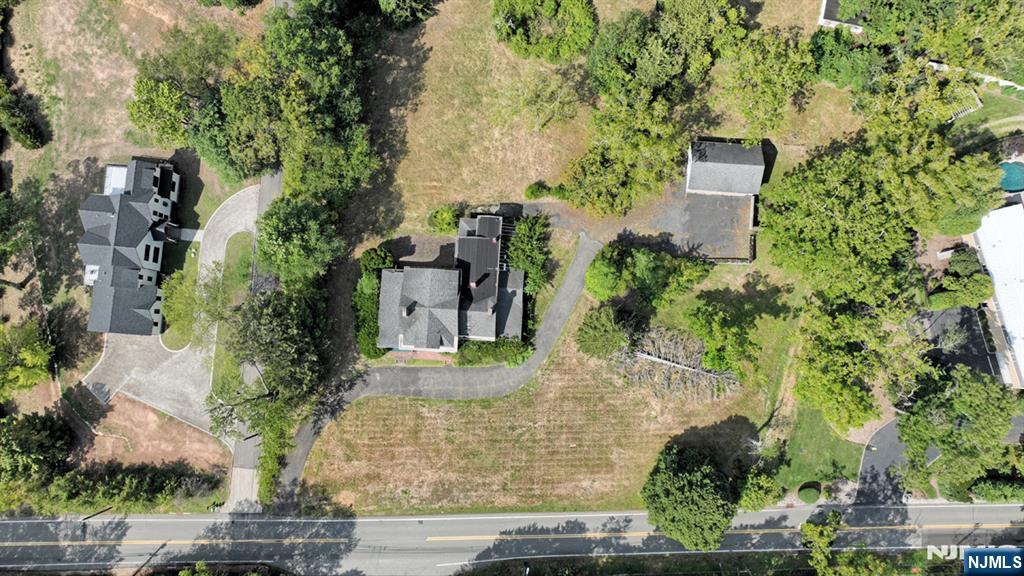 235 Wearimus Road Ho-Ho-Kus, NJ 07423 - Photo 7 of 12 an aerial view of a house with trees all around