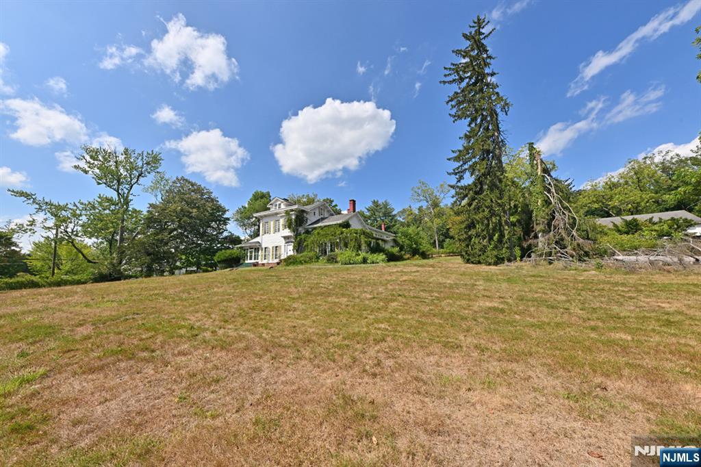 235 Wearimus Road Ho-Ho-Kus, NJ 07423 - Photo 10 of 12 a view of a house with a big yard