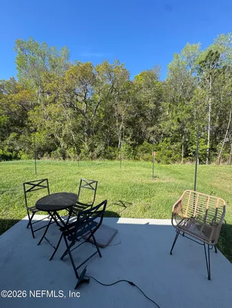 a backyard of a house with outdoor seating