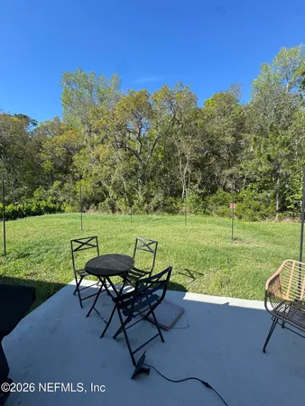 a view of a lake with furniture and a yard