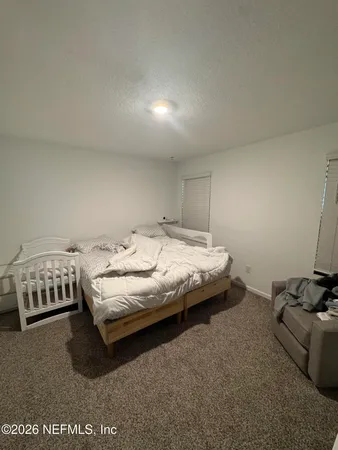 a bedroom with bed and window