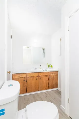 a spacious bathroom with a tub sink and mirror