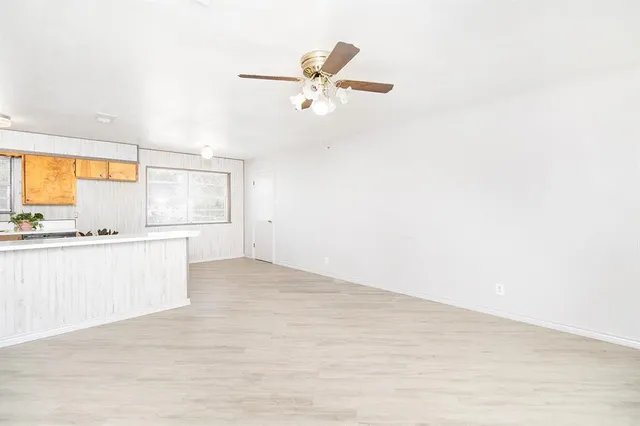 a view of kitchen with wooden floor and window