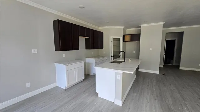 a kitchen with a sink and a stove top oven