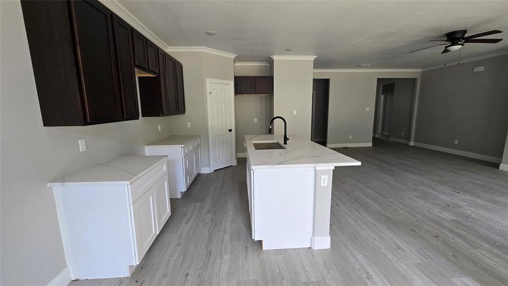 228 East Acres Road Gun Barrel City, TX 75156 - Photo 18 of 25 a kitchen with stainless steel appliances a white stove top oven a chimney wooden floor and cabinets