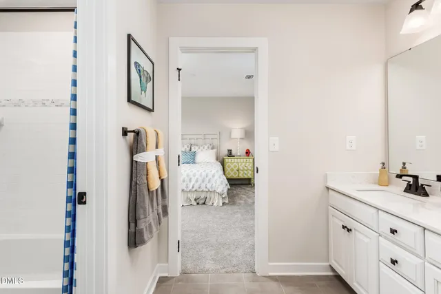 a bedroom with a bed and a table in it next to a window