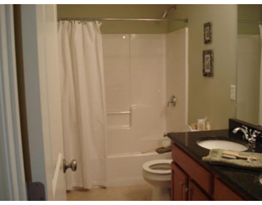 126 Smith Street, Unit 1 Lowell, MA 01851 - Photo 11 of 19 a bathroom with a granite countertop sink toilet and shower