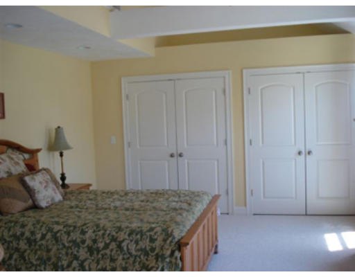 126 Smith Street, Unit 1 Lowell, MA 01851 - Photo 13 of 19 a bedroom with a bed and a cabinets