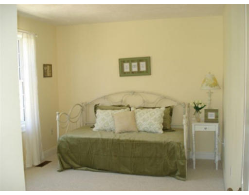 126 Smith Street, Unit 1 Lowell, MA 01851 - Photo 18 of 19 a bedroom with a bed and a painting on the wall