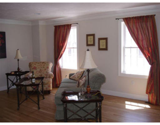 126 Smith Street, Unit 1 Lowell, MA 01851 - Photo 7 of 19 a living room with furniture and a window