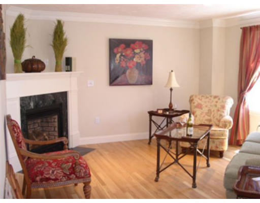 126 Smith Street, Unit 1 Lowell, MA 01851 - Photo 8 of 19 a living room with furniture a flat screen tv and a fireplace