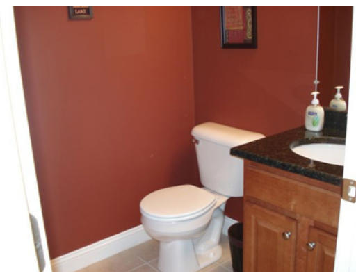 126 Smith Street, Unit 1 Lowell, MA 01851 - Photo 10 of 19 a bathroom with a granite countertop toilet and a sink