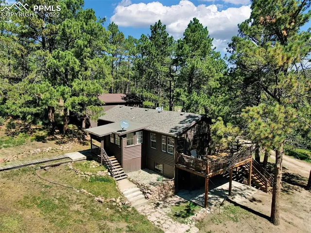 a terrace with outdoor seating and trees
