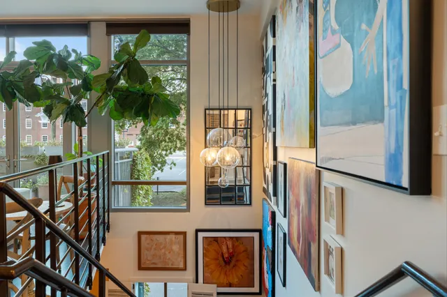 a living room with furniture fireplace and potted plants