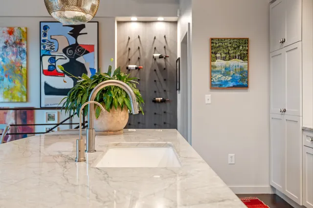 a kitchen with stainless steel appliances granite countertop a sink refrigerator and cabinets