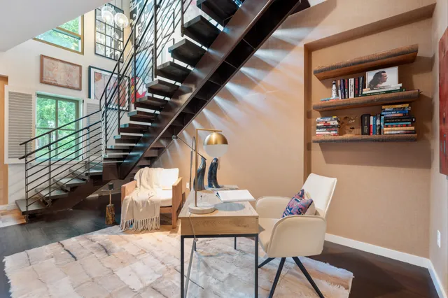 a view of a livingroom with furniture and staircase