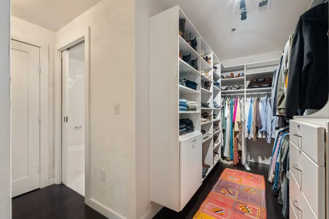 a vase of flowers sitting on a wooden floor