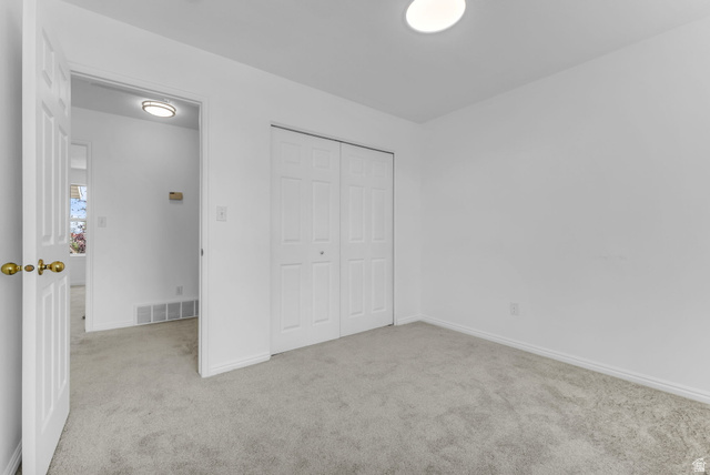 1147 West State Road Lehi, UT 84043 - Photo 24 of 31 Neutral wall paint, carpet flooring, and a flush mount ceiling light
