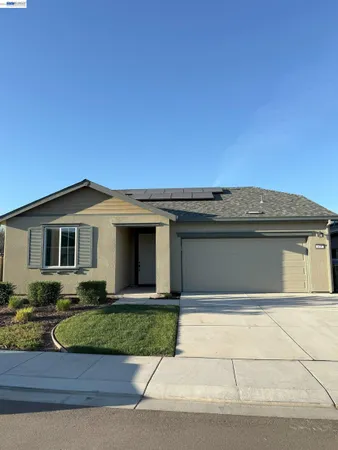 a front view of a house with garage