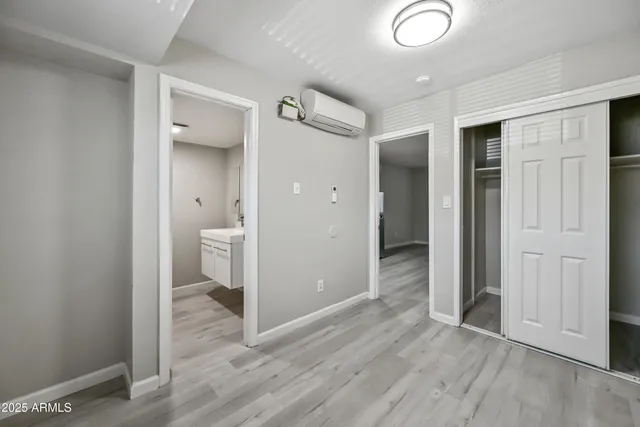 wooden floor in an empty room and a bathroom